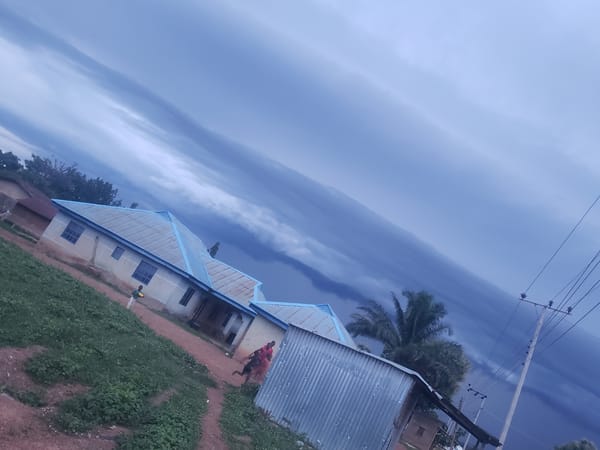 Storm clouds gather over weathered building, witness documents conditions
