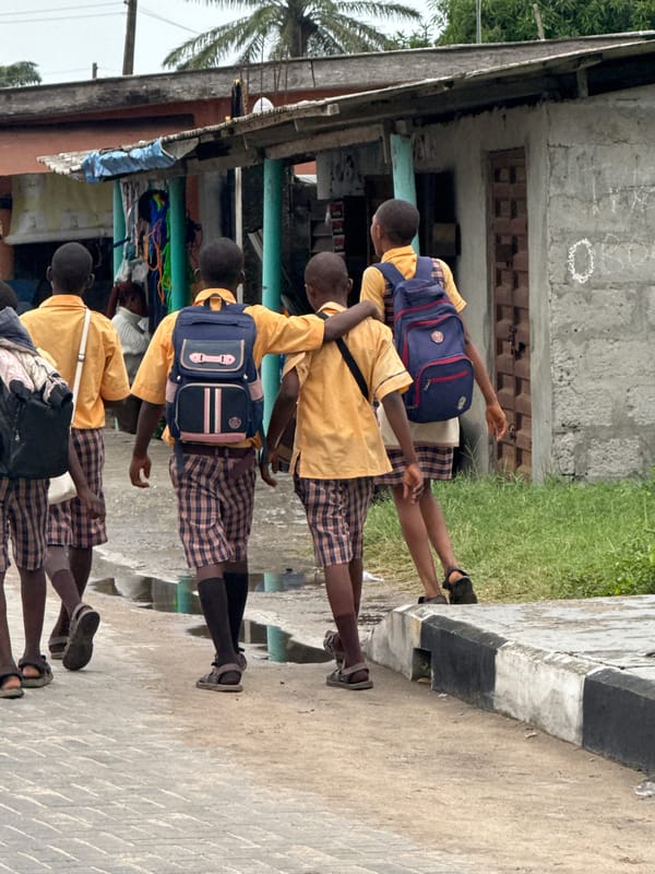 School children walk through Badagry streets during midday hours