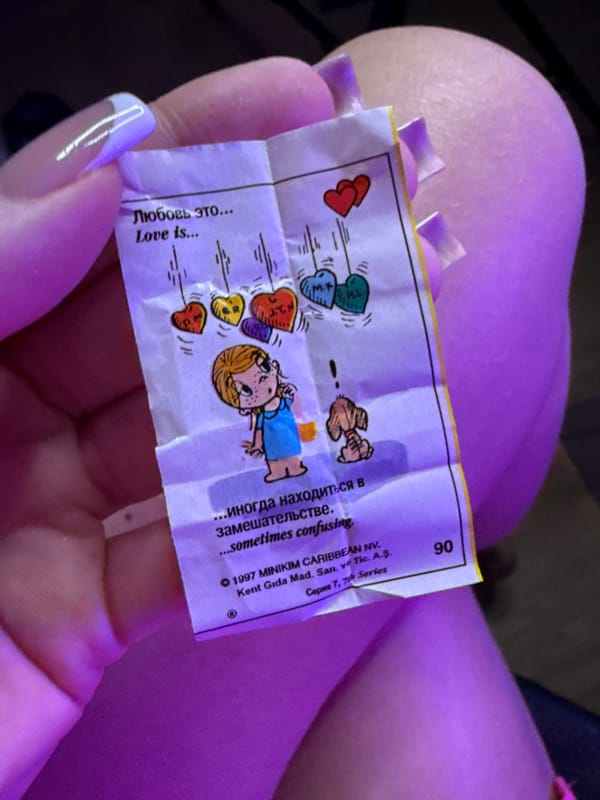Person holds illustrated paper with hearts in Batumi