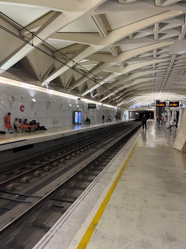 Commuters gather on Valencia subway platform during evening hours
