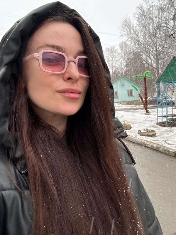 Woman photographed in spring snowfall in Kedrovy, Russia