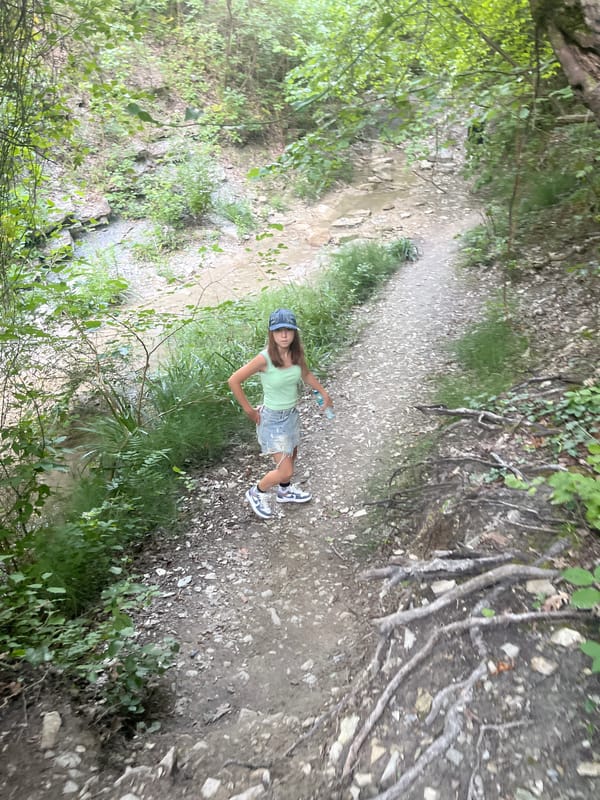 Hiking through a rocky gorge with waterfalls and forest trails