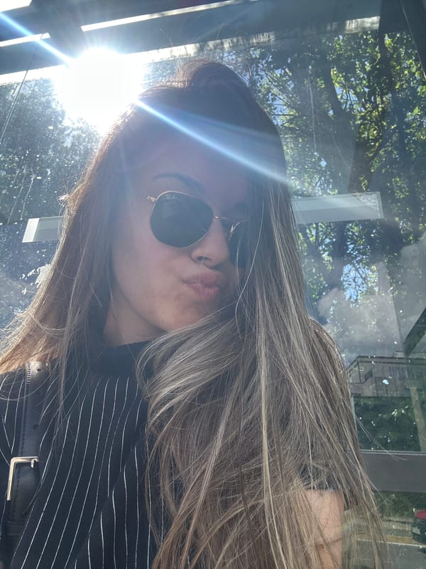 Woman takes playful selfies at Sofia bus stop