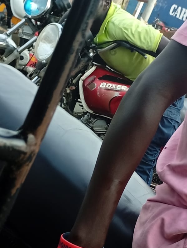 Daytime street gathering with motorcycles observed in market area