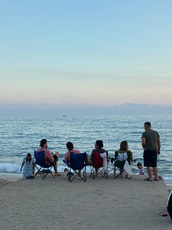 Sunset at Cleopatra Beach, Alanya — people, ships, and a sleeping cat