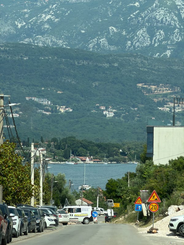 Elevated view captures road scene in Milovići, Montenegro