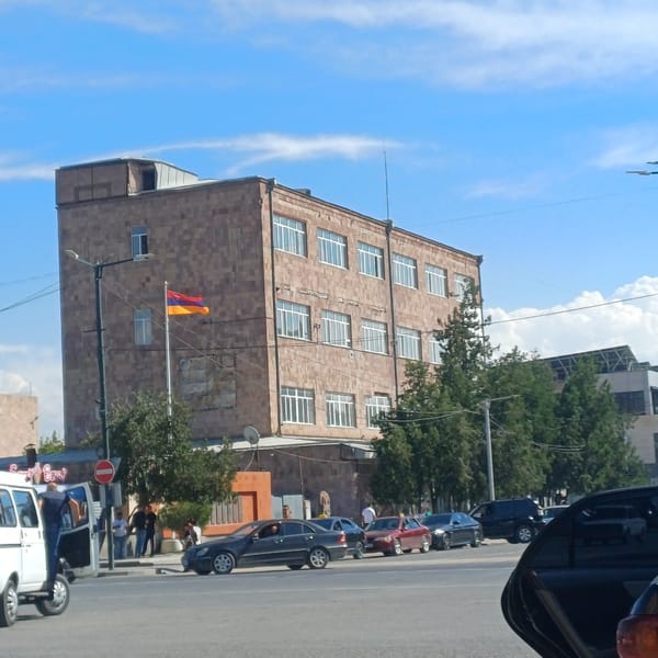 Street parking, retail shelves, and a stone building in one area