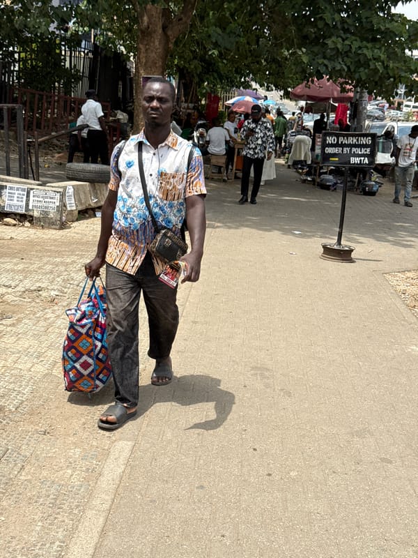Ordinary life documented across Abuja's commercial districts during midday
