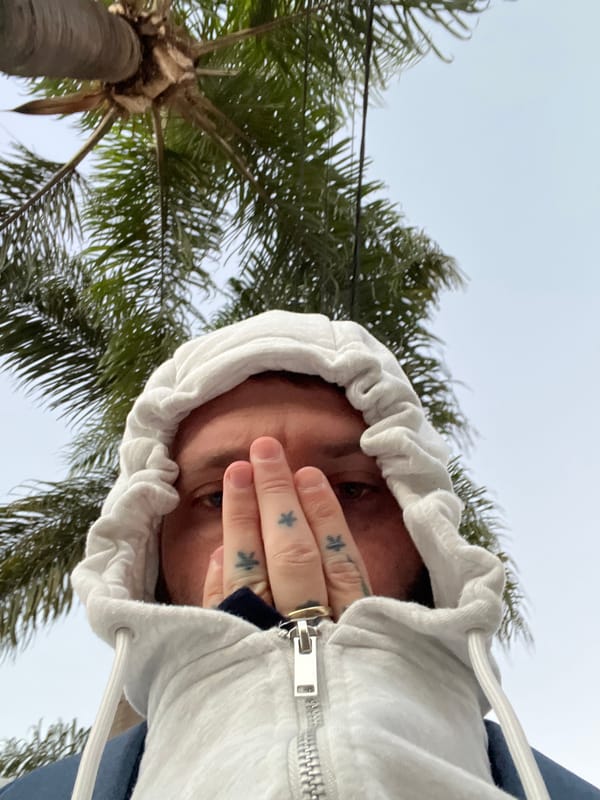 Hooded figure photographed in candid street shot, Cordoba