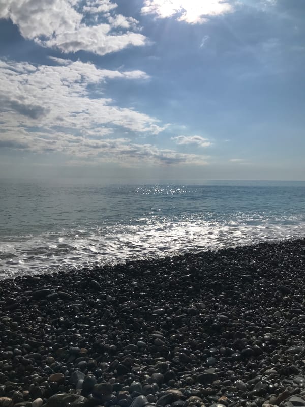 Sunny day at Black Sea pebble beach in Sochi