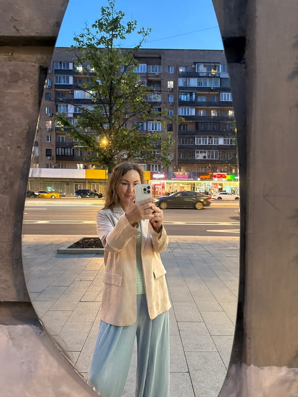 Moscow streets at dusk, pedestrians and traffic near City towers