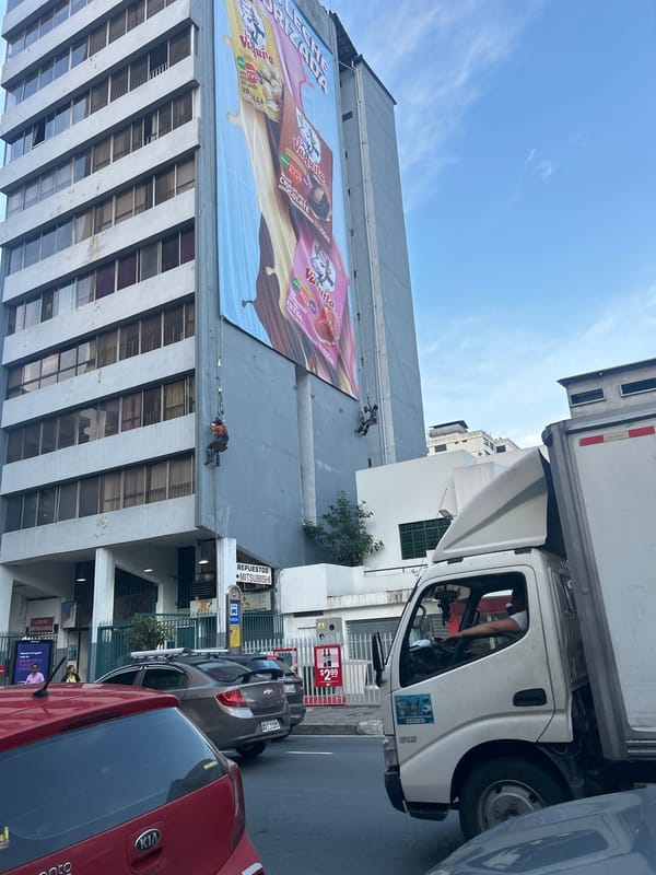 Workers Install Vaquiita Milk Advertisement in Guayaquil