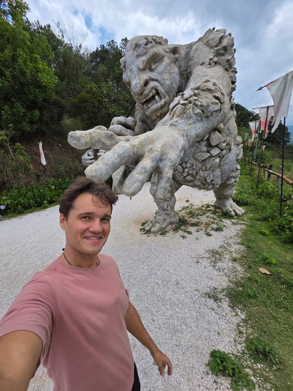 Tourists pose with stone sculptures at Vietnamese attraction site