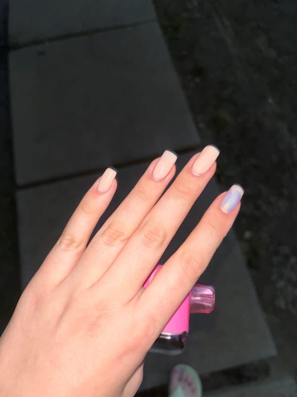 Graffiti-covered restroom stop with a vape and fresh manicure