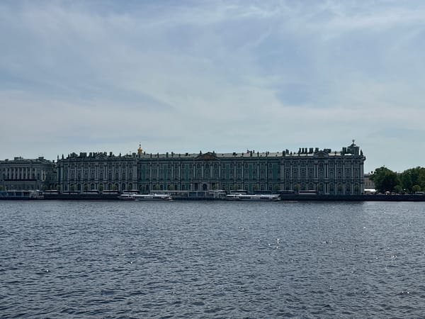 Tourist visits Winter Palace embankment in Saint Petersburg