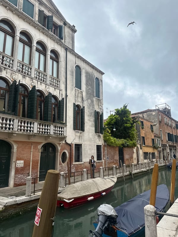 Venice canal scene captured with person on balcony