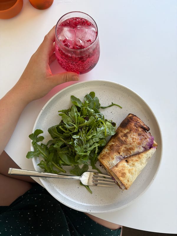 Pink berry drink and a meal, shot from above in Germany