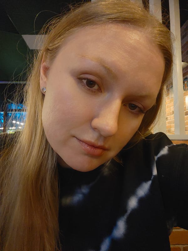 Woman enjoys sausage meal in Samara restaurant