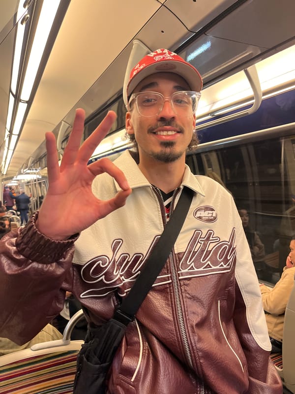 Man gestures on Paris Metro as tropical drink spotted nearby