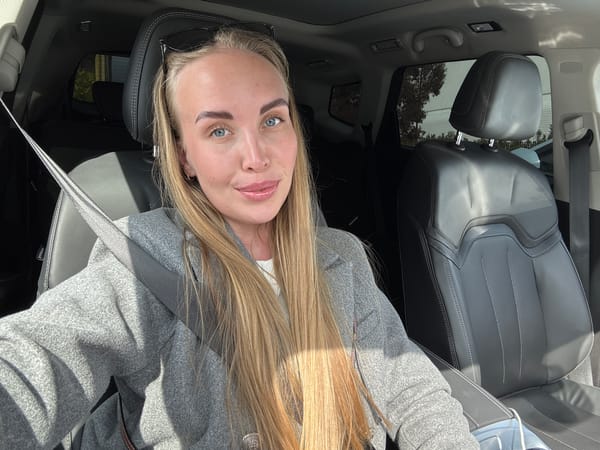 Woman takes selfies in car driver's seat in Sirius