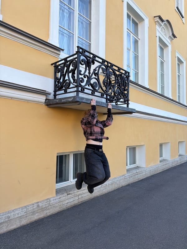 Tourists photograph historic Peterhof palace complex under clear skies