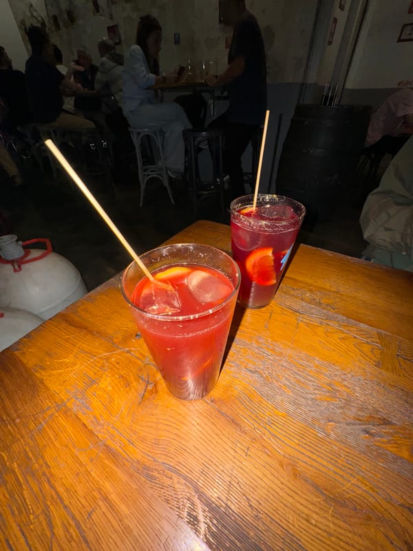 Red cocktails served on wooden table in Barcelona