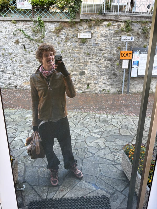 Tourist takes selfies on mountain balcony in Gittana, Italy