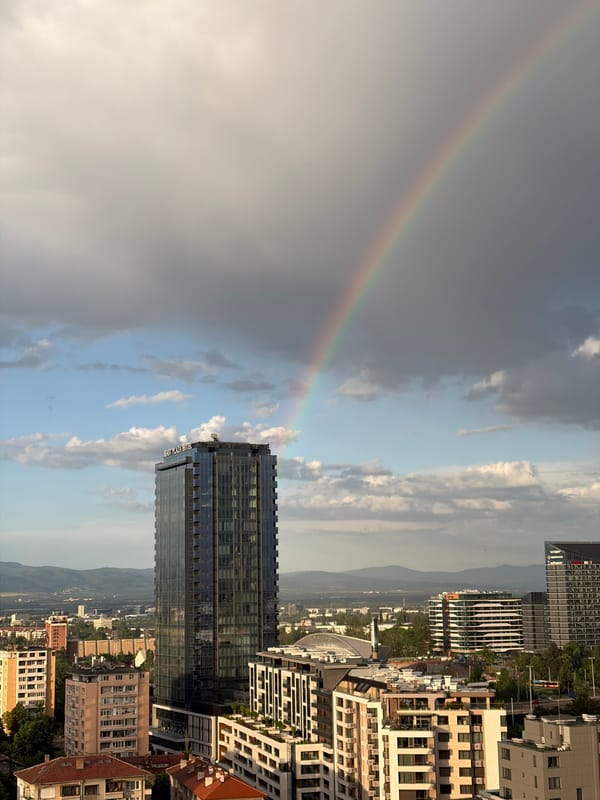 Rainbow appears over city skyline near East Plaza Hotel