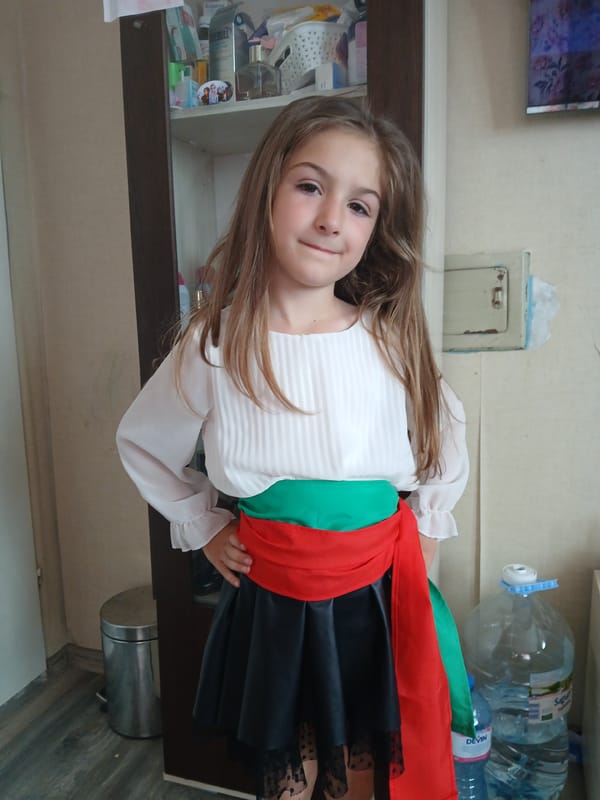 Girl in traditional dress spotted indoors in Obrochishte, Bulgaria