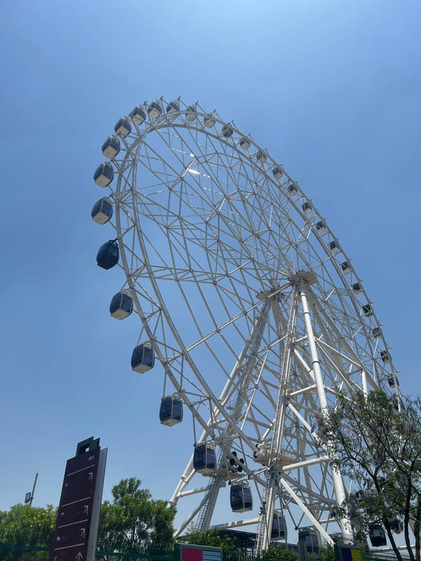 White Ferris wheel observed against blue sky in Mexico City