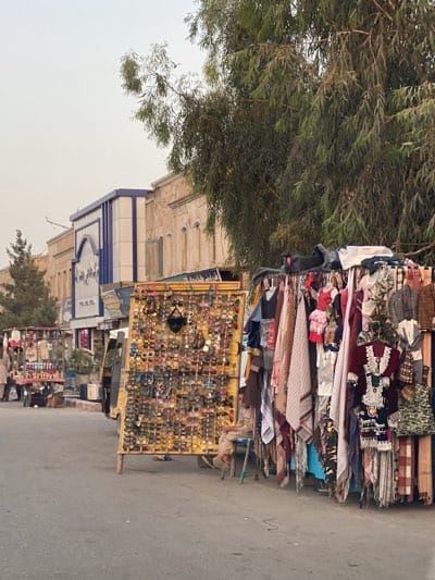 Daily street life unfolds across Kandahar's busy commercial districts