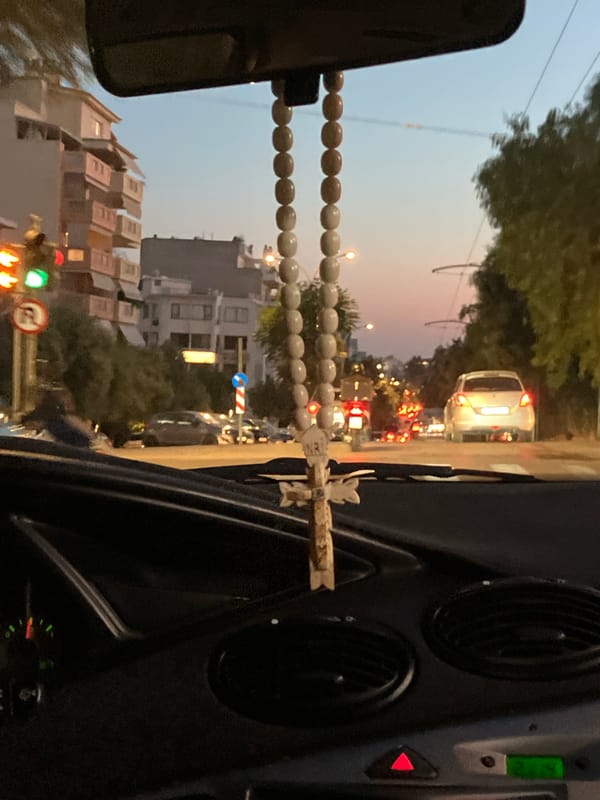 Evening road trip with a sunset and a rosary