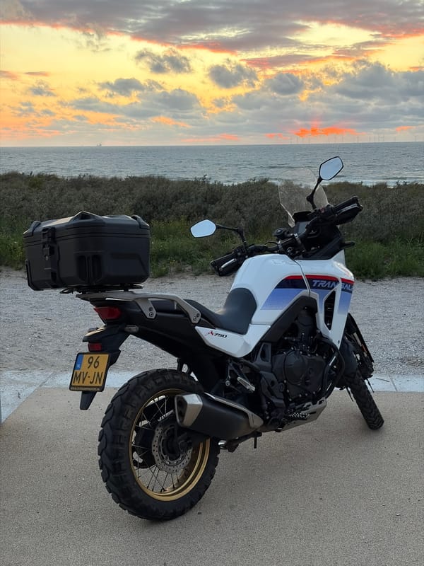 Honda Transalp parked at North Sea sunset near The Hague