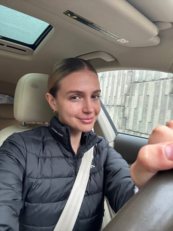 Woman takes driving selfie in Tbilisi vehicle