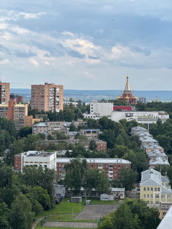 Izhevsk cityscape: old architecture, green canopy, active construction