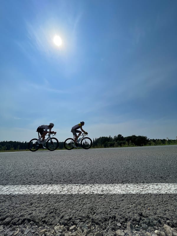 Cyclists race through Niva, Russia on a summer morning