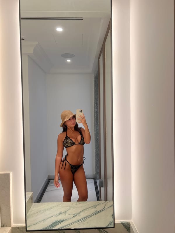 Woman documents Dubai luxury hotel visit with selfies, coconut drink