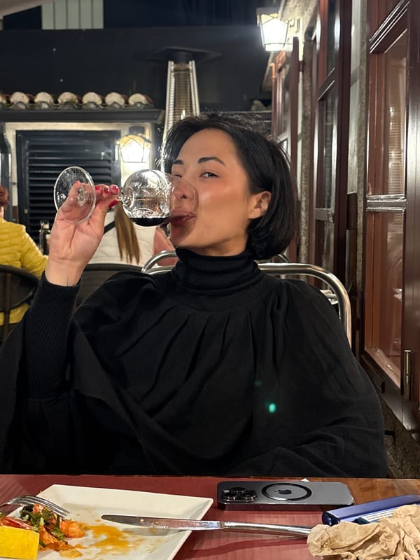 Woman enjoys drink at Santiago de Compostela restaurant