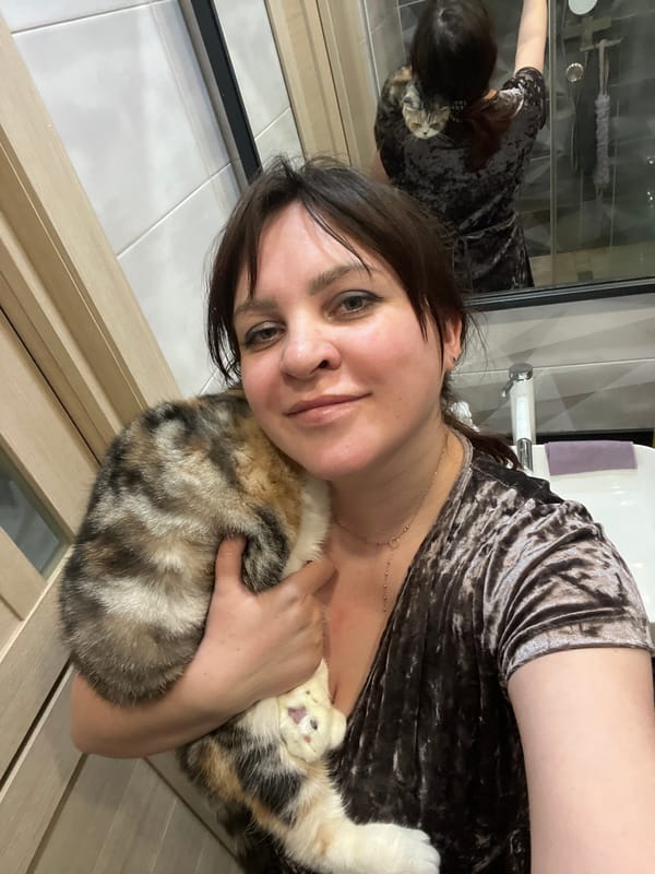 Woman photographed with Scottish Fold cat in Russian home