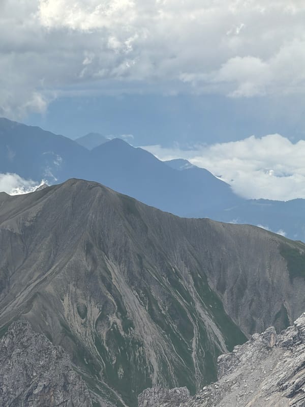Layered Alpine ridgelines rise under cloudy skies near Garmisch-Partenkirchen