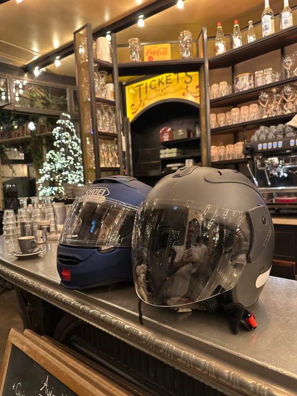 A night out at a Paris bar, helmets parked on the counter.