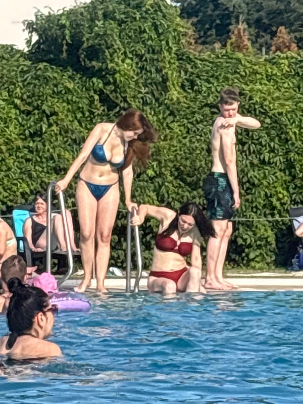 Crowded outdoor pool on a sunny summer afternoon