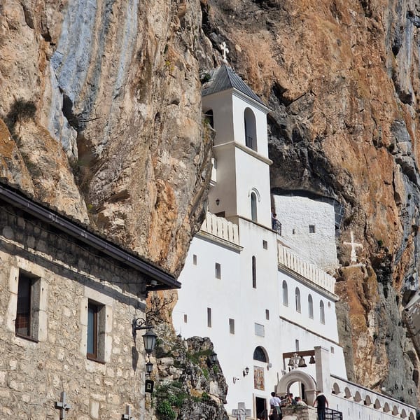 Pilgrims queue at cliff-built Ostrog Monastery in Montenegro