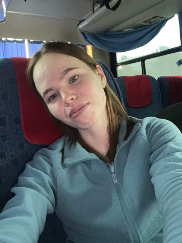 Woman rests on public transport in Bizyar, Russia