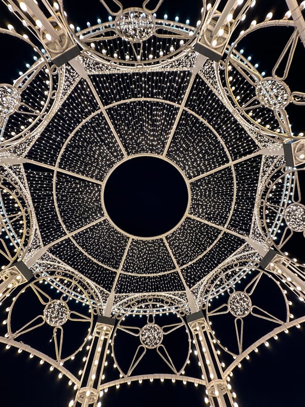 Illuminated circular metal structure photographed against night sky in Russia