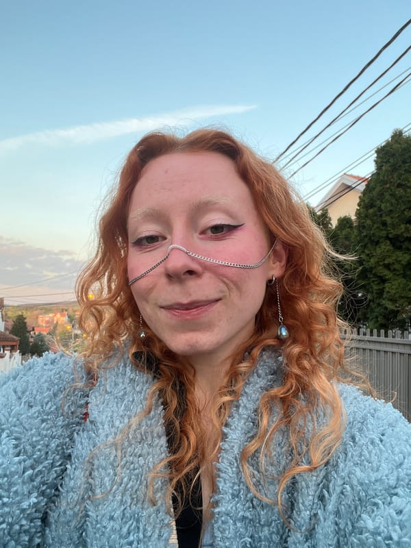 Woman takes selfies with silver chain accessories in Belgrade