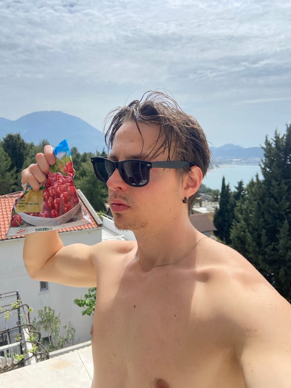 Man enjoys morning snack on balcony in coastal Montenegro