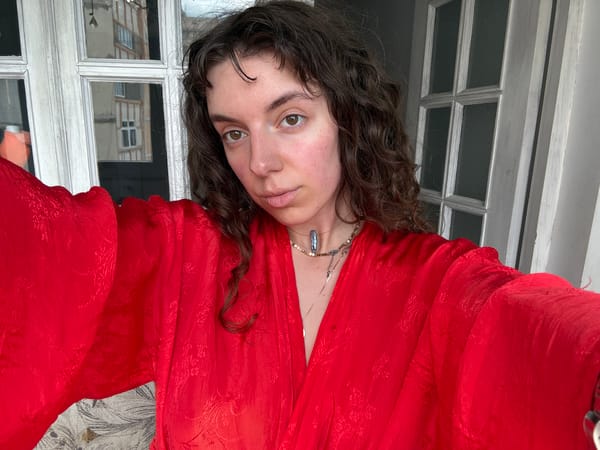 Woman in red robe juggles yellow fruits indoors