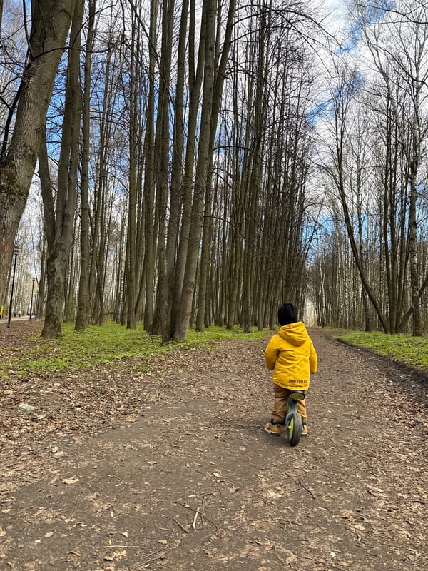 Mother and child enjoy spring morning bike ride in Rusanovo park