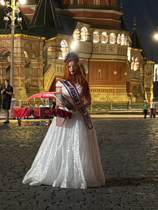 Pageant title holders pose at Red Square on a summer night